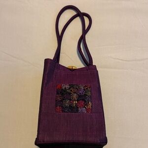 Purple Handbag with Floral Accent